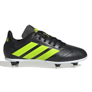 Black soccer cleat with green stripes on a white background