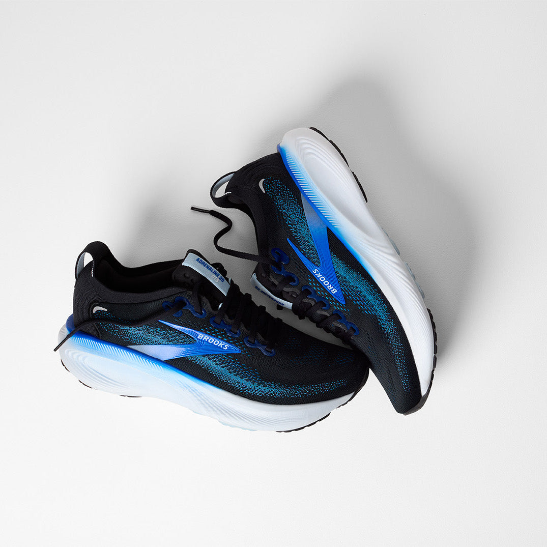 Black and blue athletic shoes on a white background