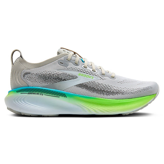 Gray running shoe with green sole on a white background