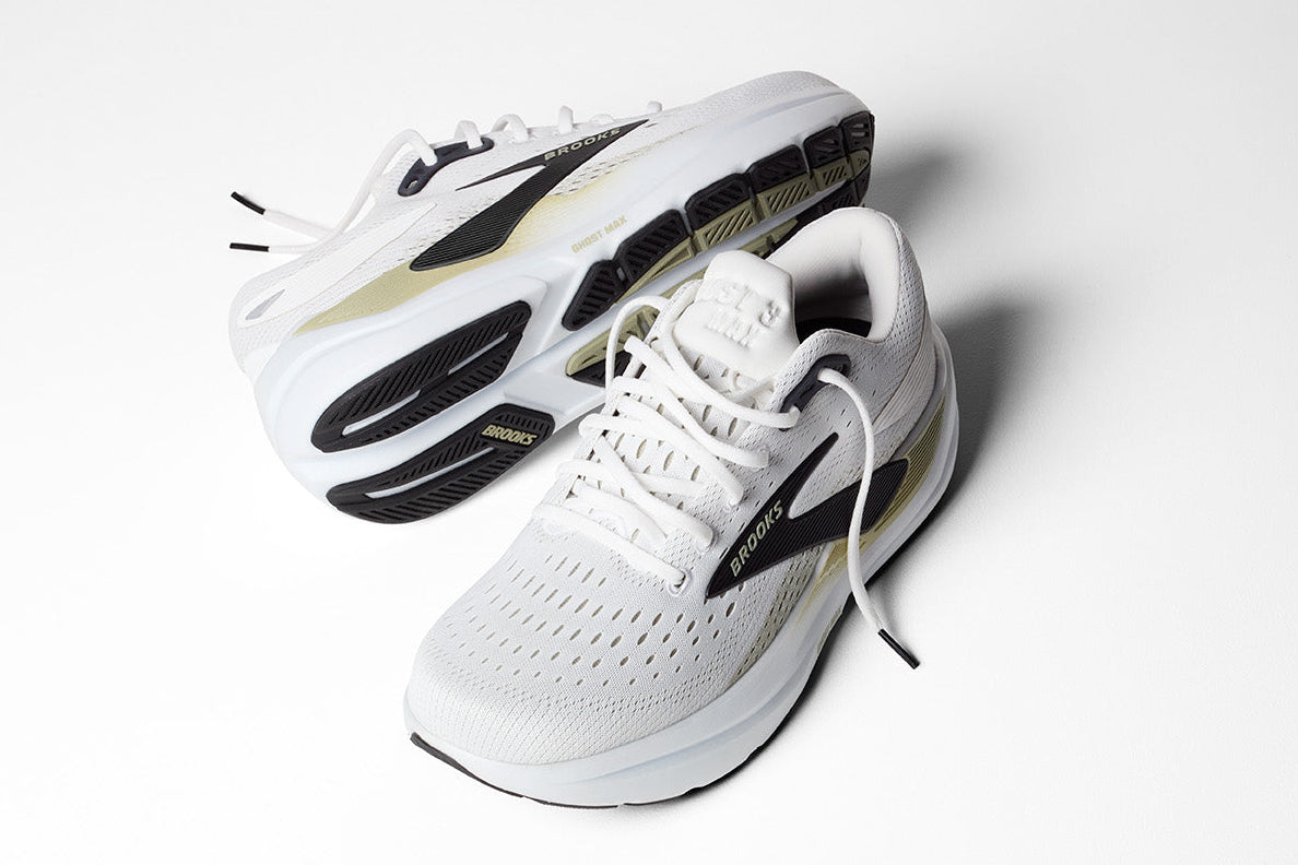 White sneakers with black and gold accents on a white background