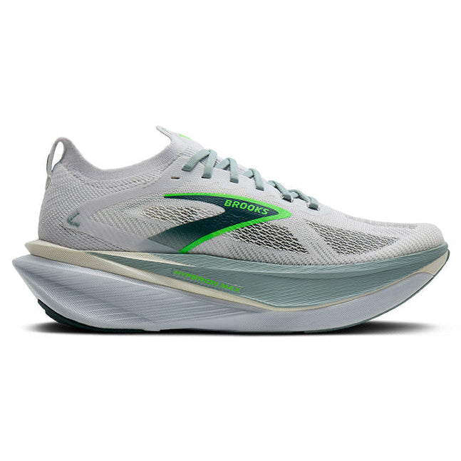White running shoe with green accents on a white background