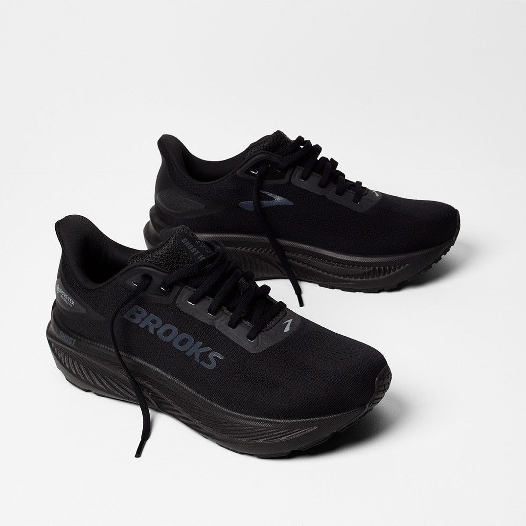 Black running shoes with 'Brooks' branding on a white background
