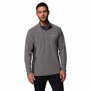 Man wearing a gray pullover with a brand logo on a white background