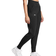 Person wearing black leggings with a visible brand logo on a white background