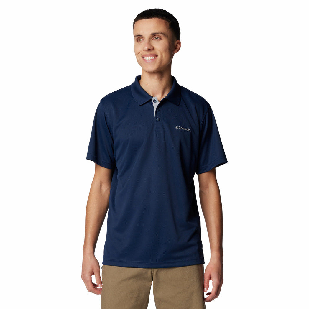 Man wearing a navy blue polo shirt with a brand logo on a white background
