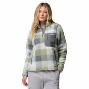 A woman modeling a quarter-zip fleece pullover with a muted green, gray, and white plaid pattern, paired with light gray sweatpants, against a solid white background.