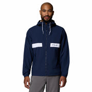 Man wearing a navy blue jacket with white accents on a white background