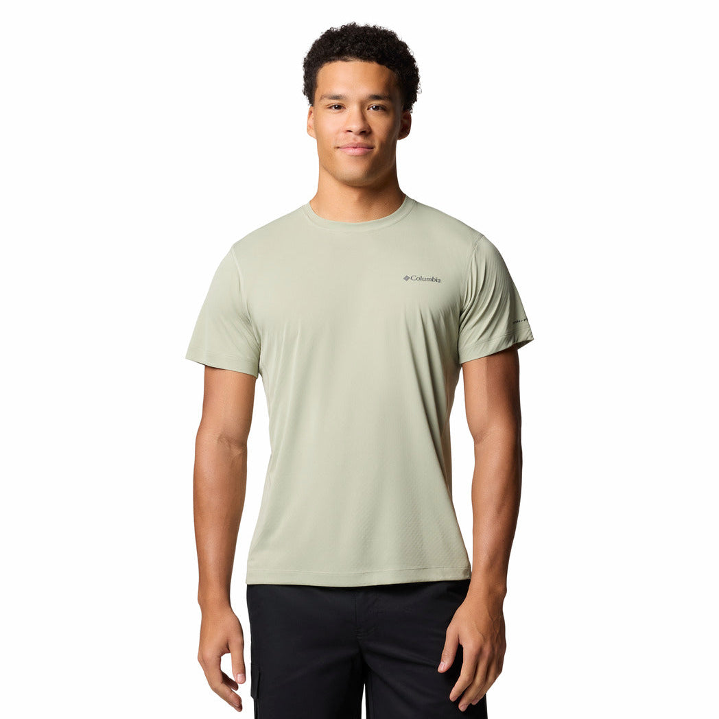 Man wearing a light green t-shirt with a brand logo on a white background