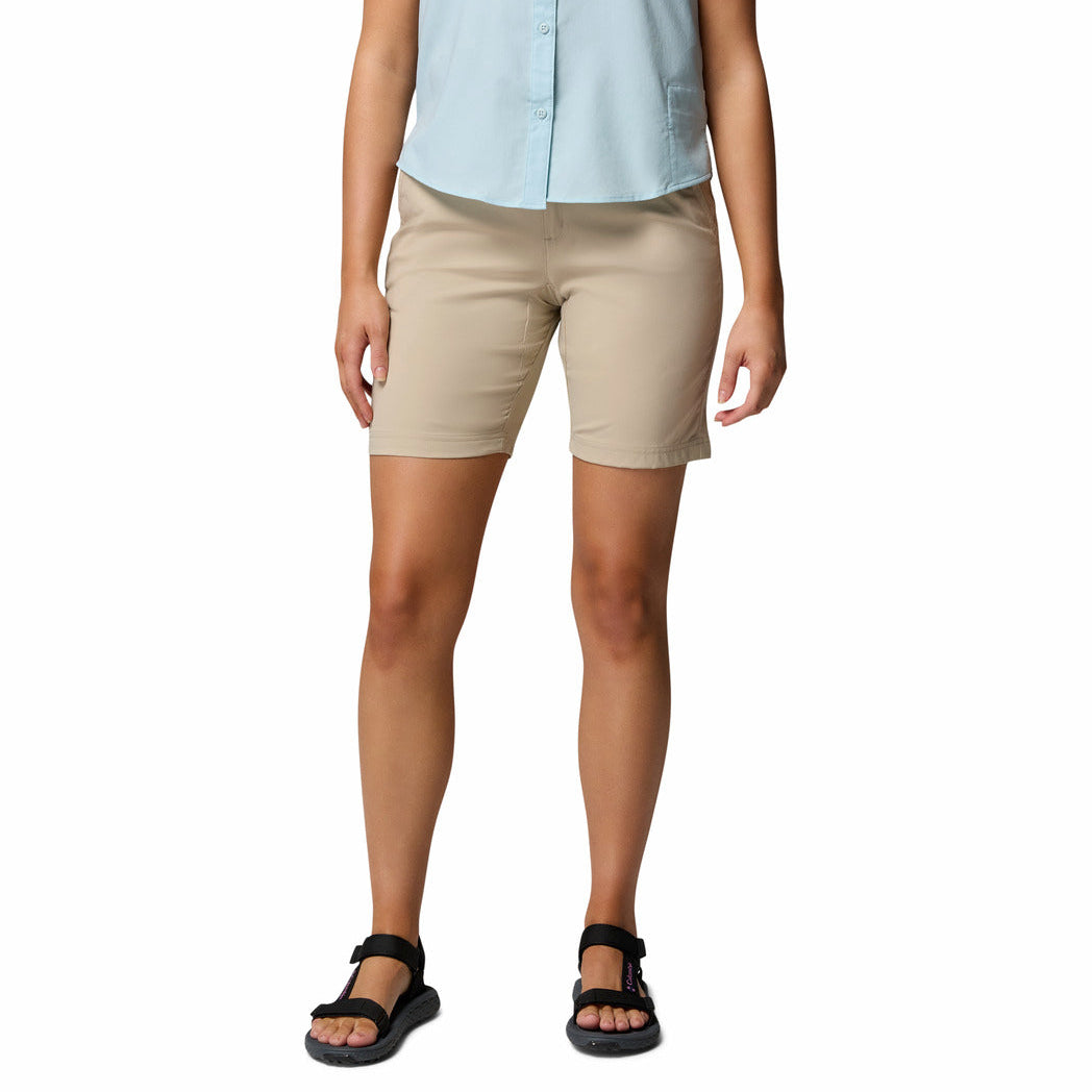 Person wearing beige shorts and a light blue shirt on a white background
