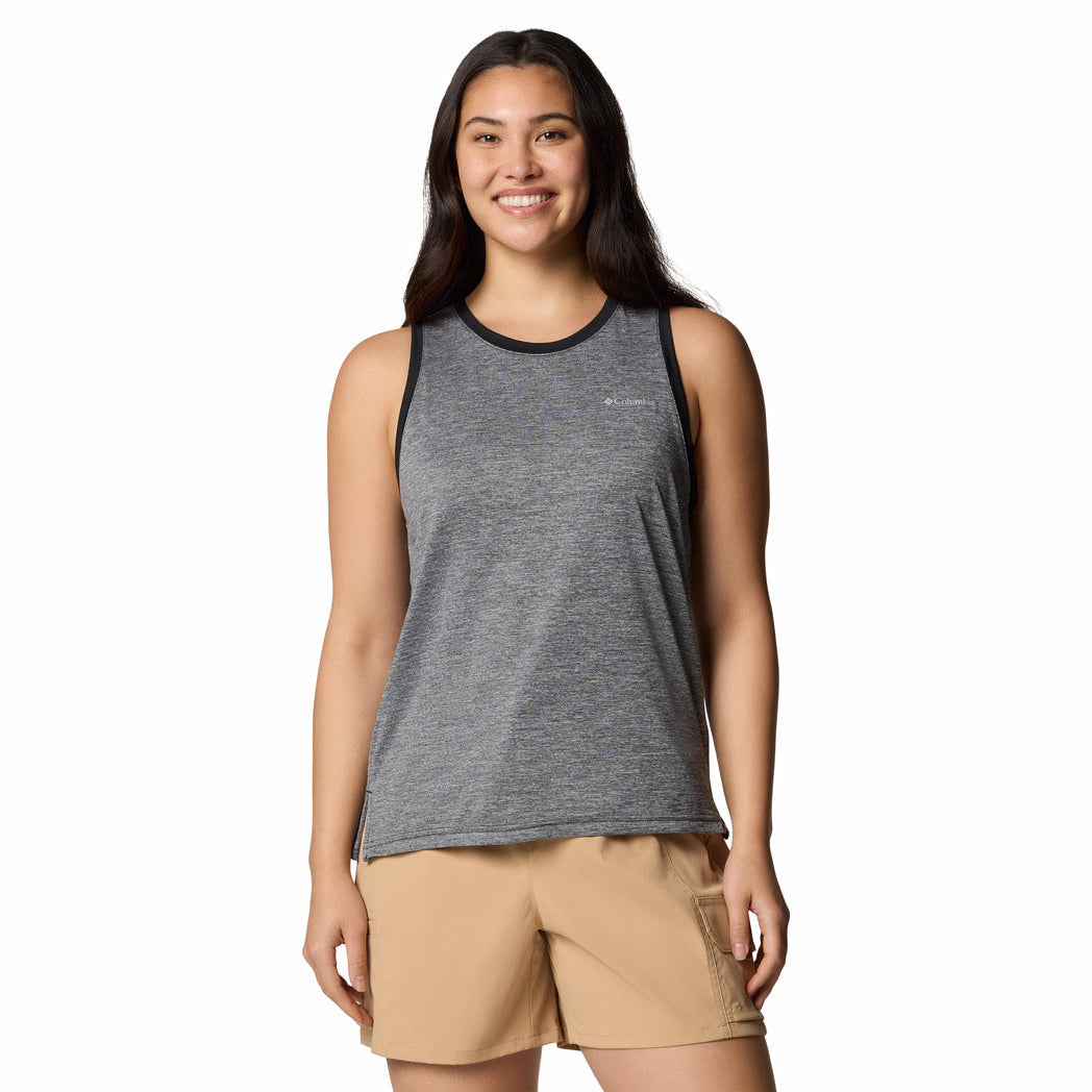 Woman wearing a gray tank top and beige shorts on a white background