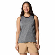 Woman wearing a gray tank top and beige shorts on a white background