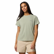 Woman wearing a light green t-shirt with a brand logo on a white background