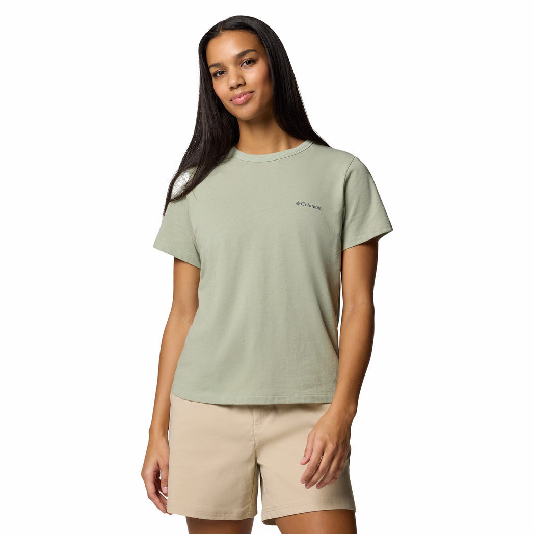Woman wearing a light green t-shirt with a brand logo on a white background