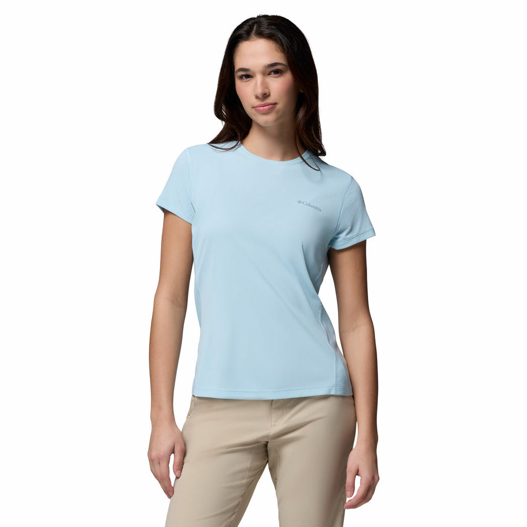 Woman wearing a light blue t-shirt and beige pants on a white background