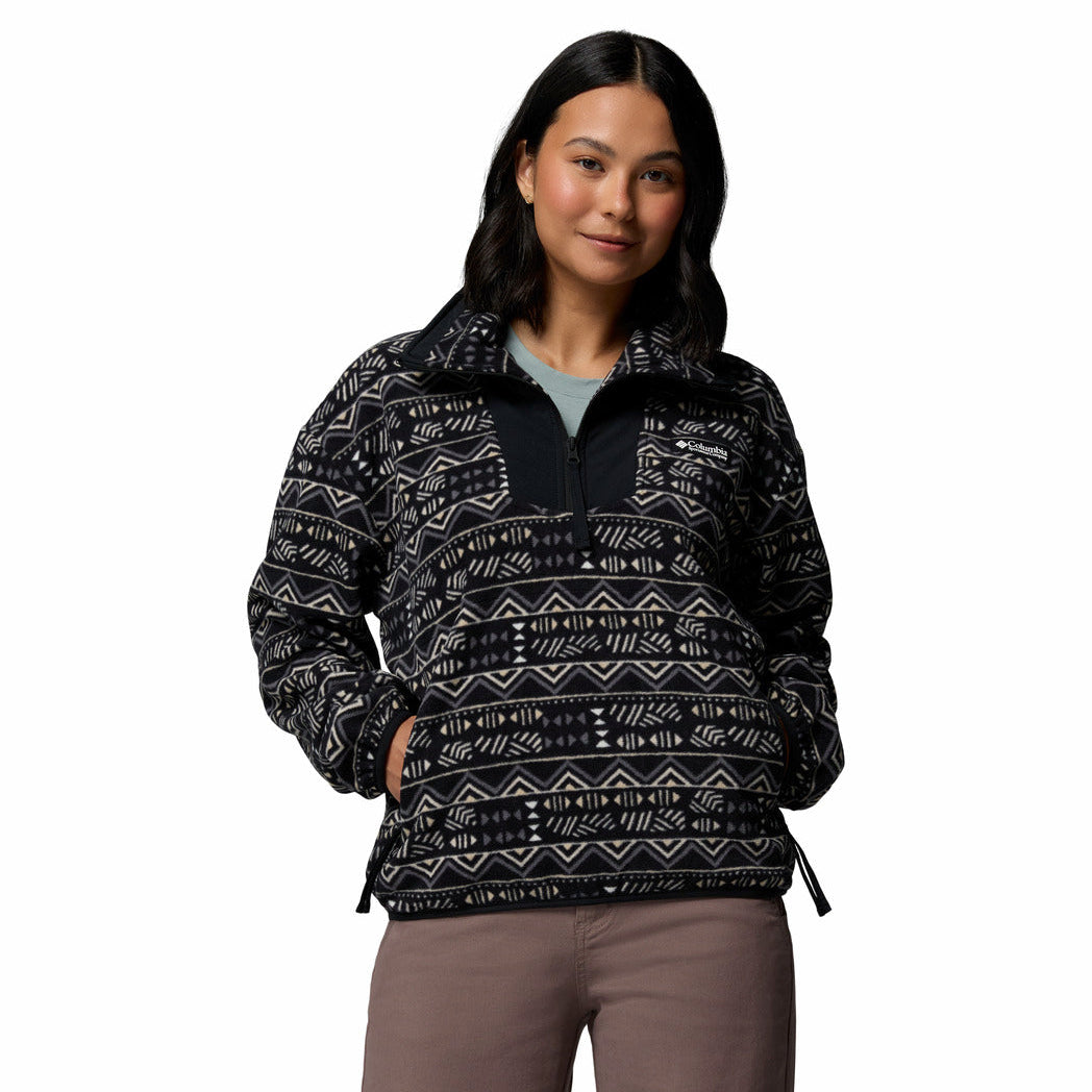 Woman wearing a patterned black and white jacket on a white background