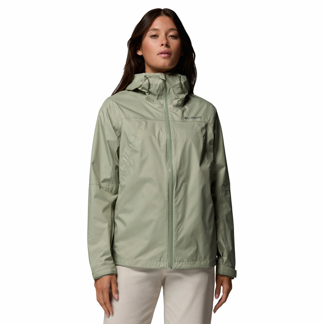 Woman wearing a green raincoat on a white background