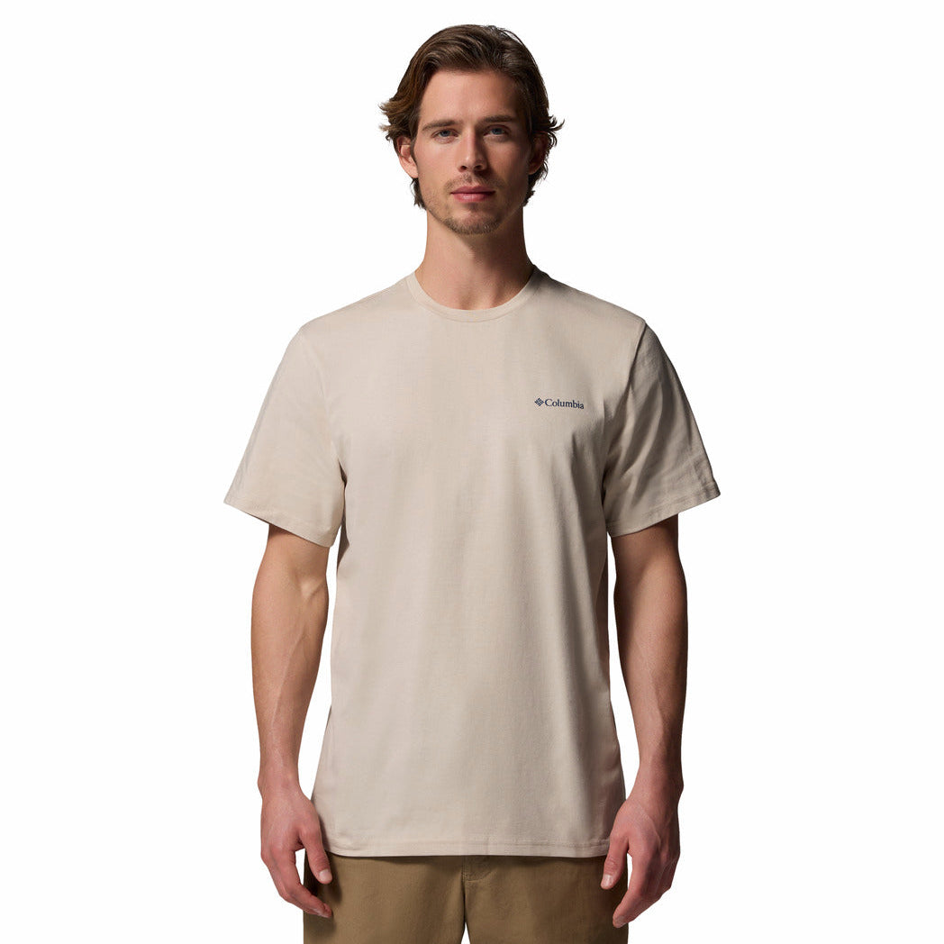 Man wearing a beige t-shirt with Columbia logo on a white background