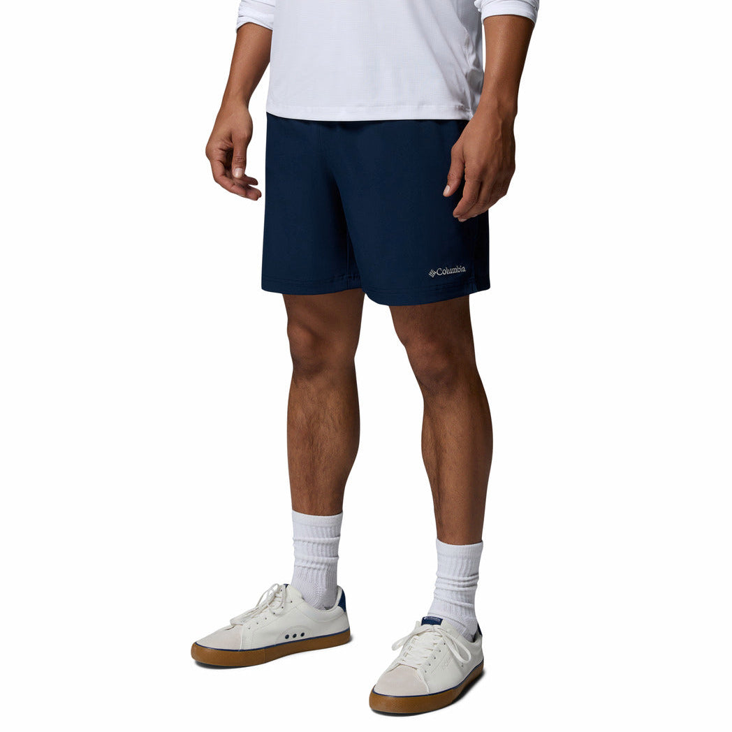 Person wearing navy Columbia shorts on a white background