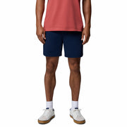 Person wearing navy shorts and a red shirt on a white background