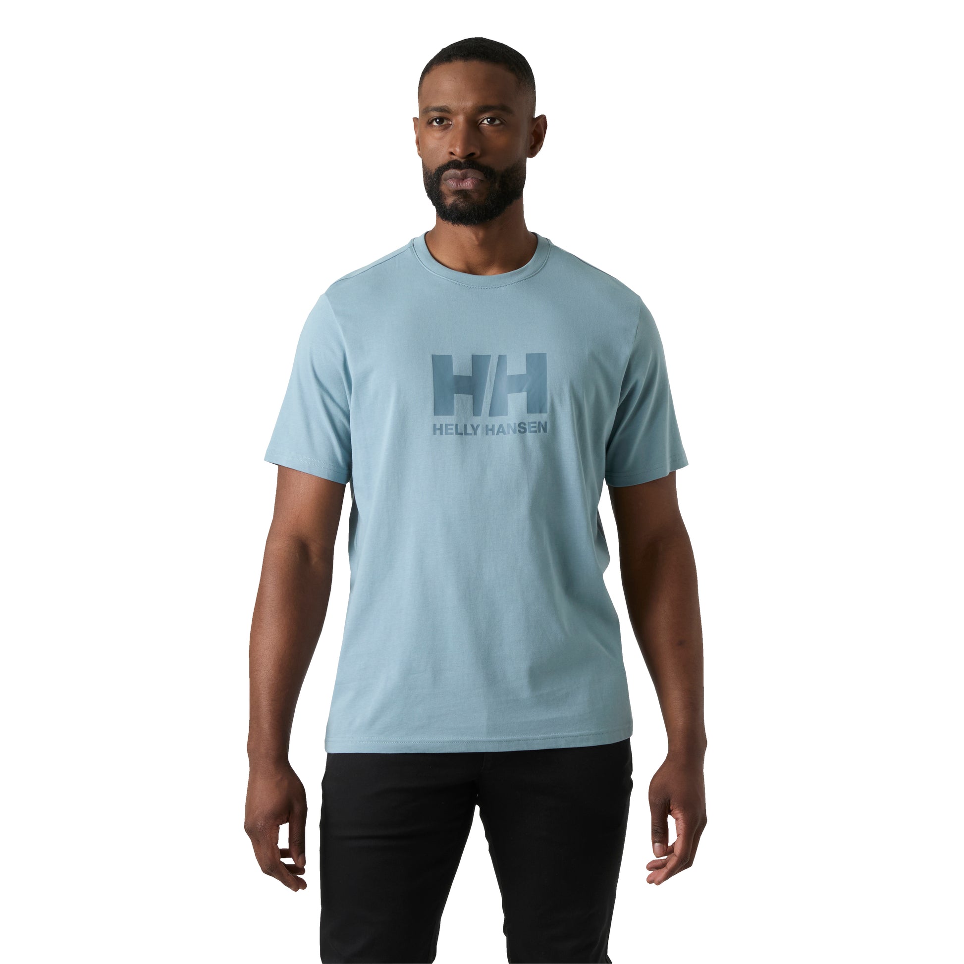 Man wearing a light blue Helly Hansen t-shirt on a white background