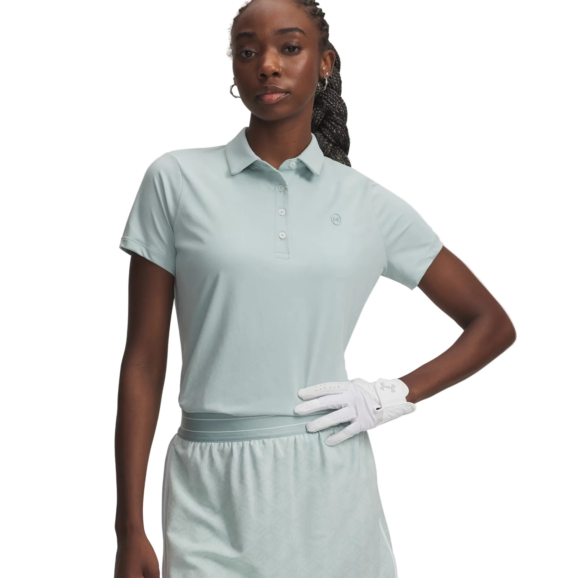 Woman wearing a light blue polo dress and white golf glove on a white background