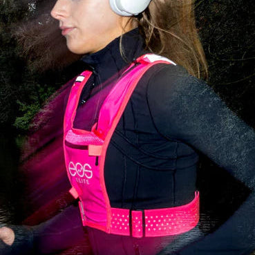 Person wearing a pink running vest with product details on the right