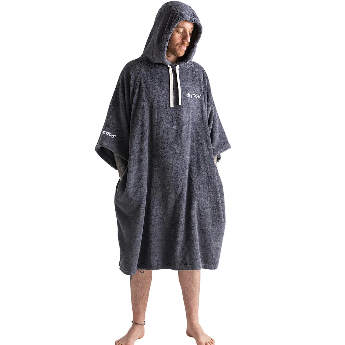 Person wearing a gray hooded poncho with a brand logo on a white background