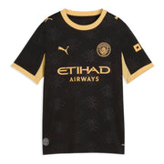 A black short-sleeve soccer jersey with gold trim, featuring the Puma logo, Manchester City crest, and Etihad Airways sponsor on the front, set against a plain white background.