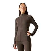 A woman modeling a dark brown long-sleeve athletic zip-up jacket and matching leggings against a solid white background.