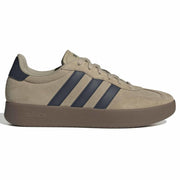 Beige Adidas sneaker with three black stripes on a white background
