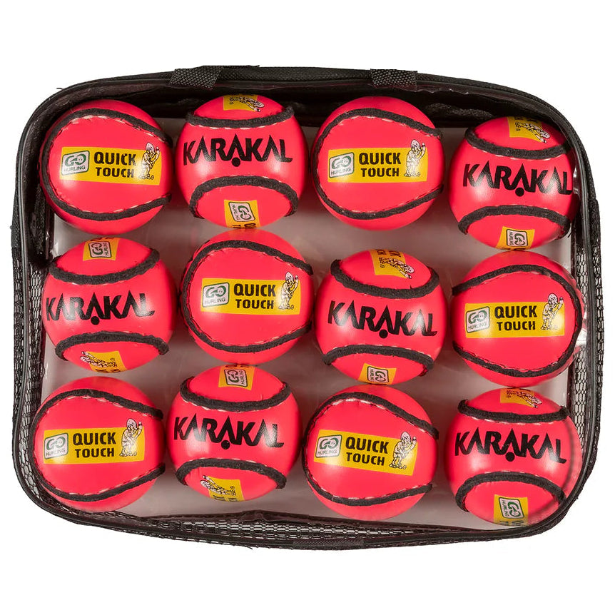Set of red Karakal quick touch tennis balls in a black carrying case on a white background