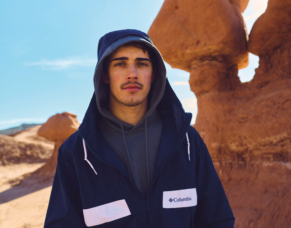 Person wearing a Columbia jacket in front of desert rock formations