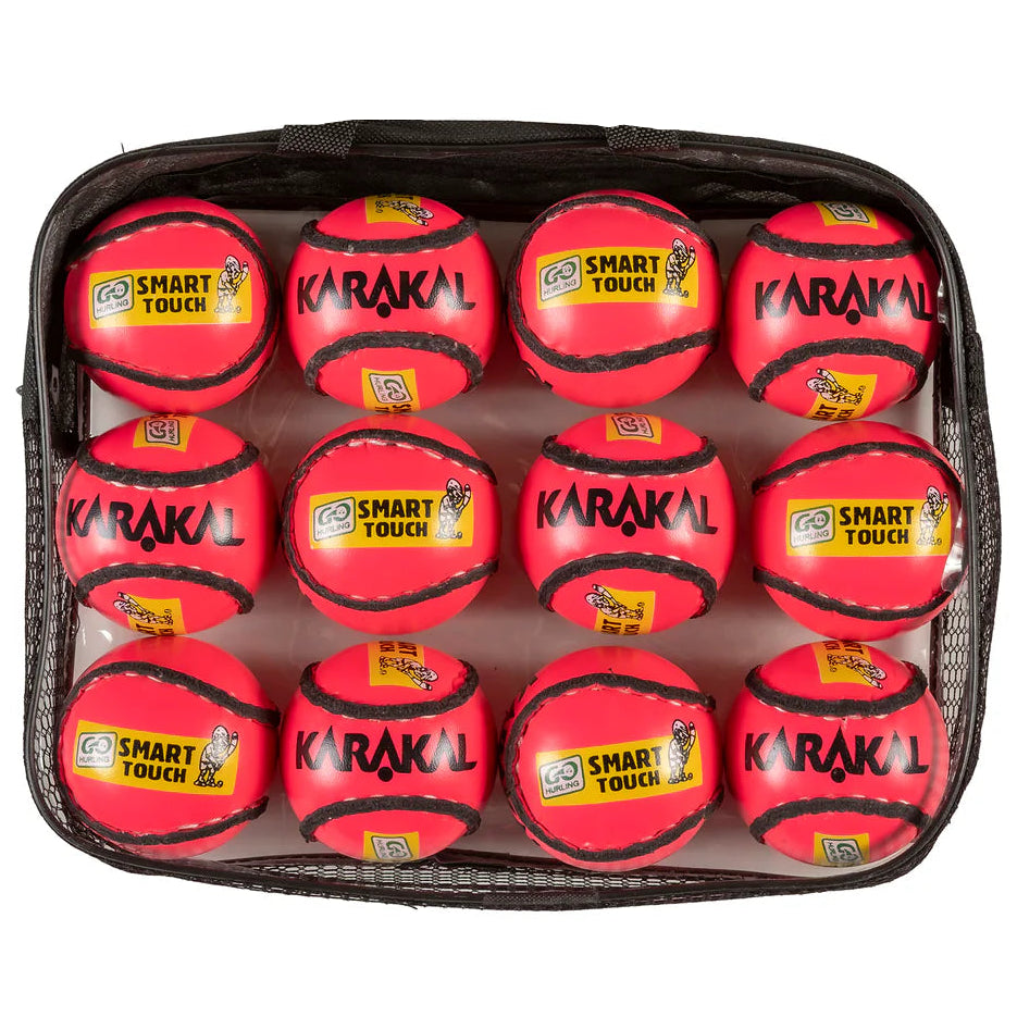 Set of red sports balls with 'Karakal' branding in a black carrying case on a white background