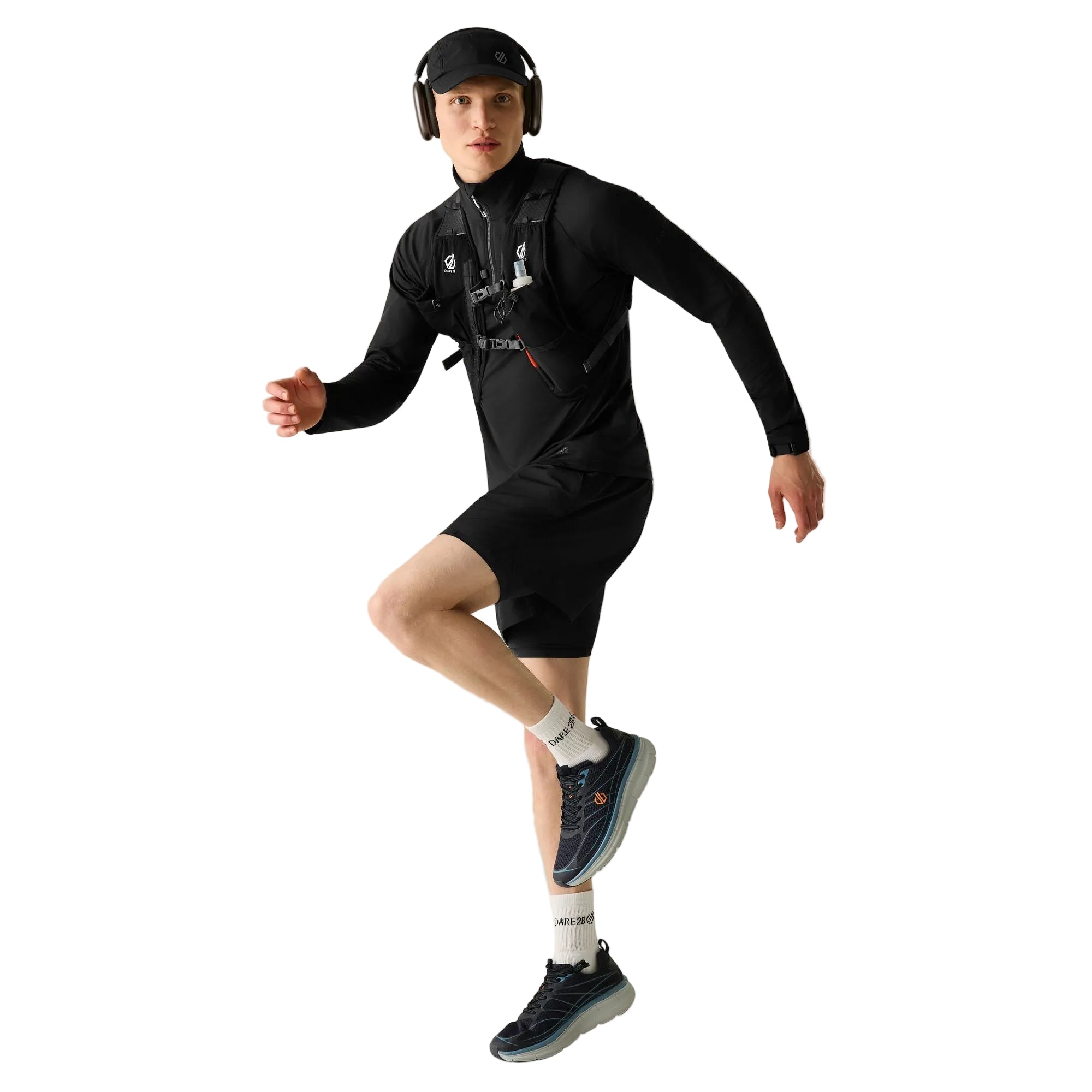 Person wearing a black athletic outfit with headphones on a plain background