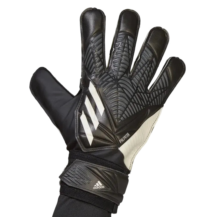 Black Adidas soccer glove on a light gray background