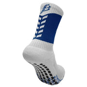 A single athletic crew sock shown from a three-quarter angle on a light gray background. The sock is primarily white with a bold blue band around the upper calf, white geometric patterns on the leg, and black grip dots on the sole with blue accents.