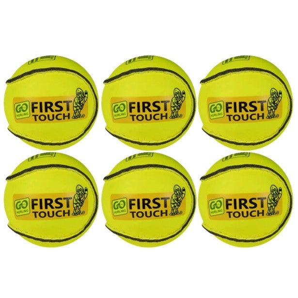 Six yellow tennis balls with 'First Touch' branding on a white background