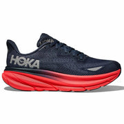 Blue running shoe with red sole on a white background