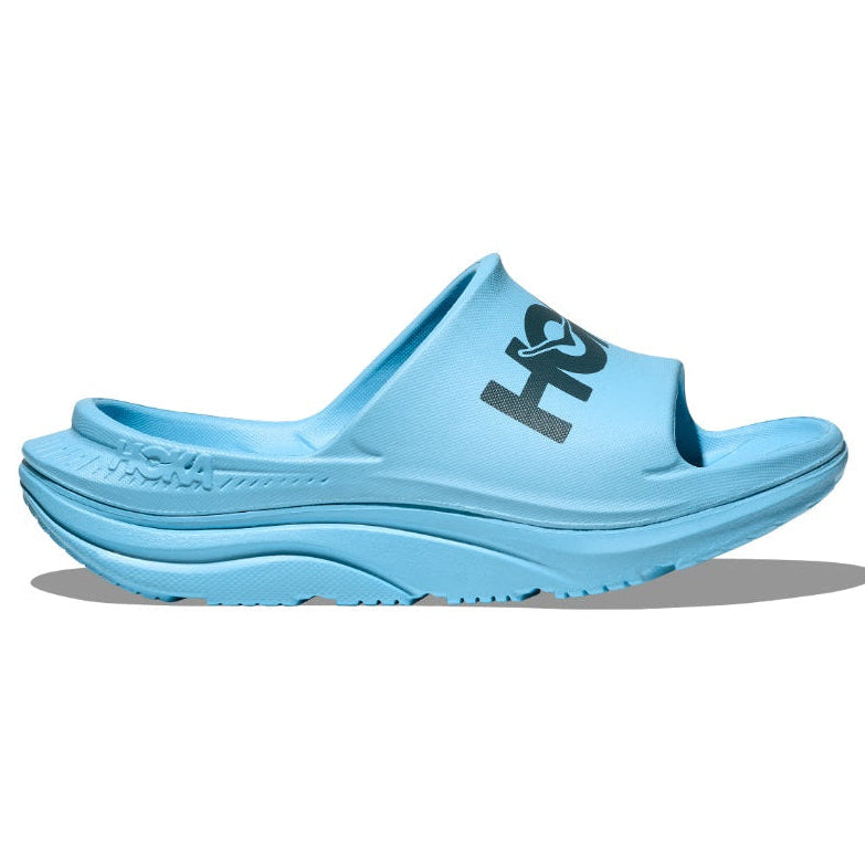 Light blue slide sandal with a brand logo on a white background
