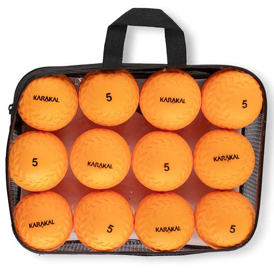 Pack of 12 orange sports balls with 'Karakal' branding in a black carrying case on a white background