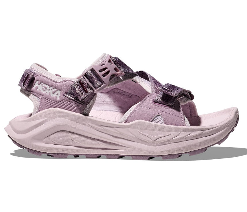 Pink sandal with black straps on a white background