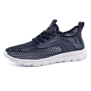 Navy blue athletic shoe with white sole on a white background