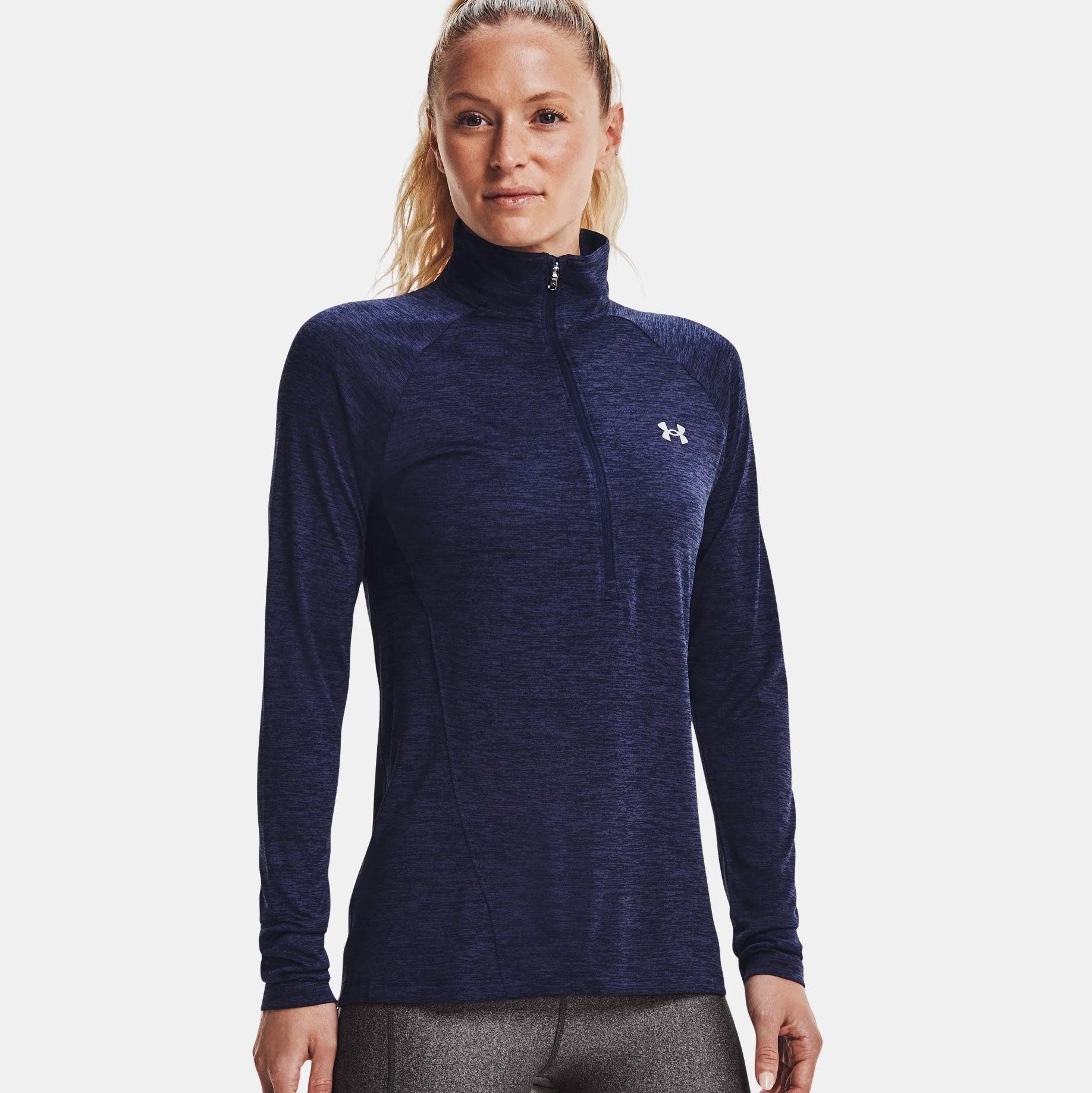 Woman wearing a navy blue long-sleeve athletic shirt with a brand logo on a white background